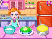 Screenshot of the Baby Colorful Cake game showing a fully decorated rainbow layer cake, a free online baking and cooking game.