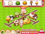 Screenshot of the 'Cake Town' online game showing colorful buildings made of cake, frosting, and candies with cute pastry-themed characters walking around