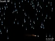 Screenshot of Bullet Rain free online arcade game showing a small ball of fire dodging a dense pattern of blue raindrops.