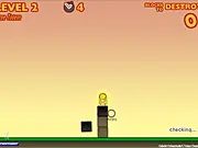 Screenshot of the Totem Destroyer 2016 game, showing a gold idol resting precariously on top of various colored blocks.
