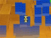 A pixel-art blocky racing car driving over and jumping large lego blocks in a colorful free online game.