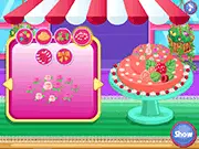 Screenshot of the free online baking game Sweet Fashion Hat Cake, showing a beautifully decorated, multi-layered cake shaped like an elegant hat with ribbons and flowers