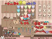 Screenshot of Momocheet's Cupcake Bakery game showing a fully decorated cupcake with frosting, cherries, and glitter on a bakery display.