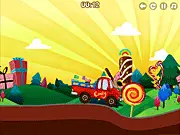 The Candy Rush game screen showing a small truck with a large pile of colorful candy driving over a bumpy, grassy hill, Play Free Online Game