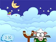 The Garfield Sheep Shot game screen showing the grumpy cat Garfield sleeping, while a sheep is launched from a slingshot-like device towards complex obstacles.