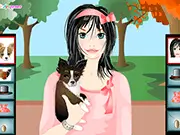 A lovely girl carrying her small Chihuahua in the park, both styled in coordinated outfits in the Chihuahua Dressup free game.