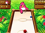 Screenshot of Zoo Hockey game, showing two paddles and a puck on a colorful air hockey table with the pink bird opponent; Play this free arcade game now