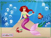 Screenshot of the Ocean Mermaid Princess dress-up game, featuring a beautifully designed mermaid character surrounded by a selection of glittering tails and seashell tops.