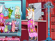 Screenshot of Elva at the Beach game showing the model Elva in a stylish summer outfit and swimsuit at a tropical beach setting.