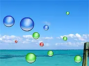 The main gameplay screen of the arcade game Biggification, showing the player's entity growing in size while collecting various colored balls