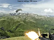 Screenshot of the Mountain Defence game showing a player aiming a gun to shoot paratroopers descending from the sky over a mountain landscape