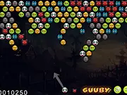 The gameplay screen of Bubble Halloween Deluxe showing a cannon at the bottom aiming to shoot a pumpkin bubble into a large cluster of colored bubbles with bats and ghosts at the top