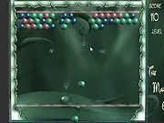 The Marble free online match 3 puzzle game screenshot showing a colorful chain of marbles moving along a track.