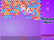 The main gameplay screen of Bubble Shooter Explosion, showing a cannon aiming a red bubble at a large cluster of blue, green, and yellow bubbles at the top of the screen.