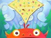 Screenshot from the Need For Feed game showing a green monster waiting to eat a cookie that is about to be cut by the player