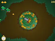 Zombies Versus Pumpkins free online game screenshot, showing Jack o' Lantern operating a pumpkin cannon to blast zombies.