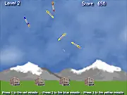 Free online Global Defense game screenshot, showing a defense cannon firing a colored missile at an incoming colored enemy missile.