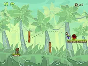 Hungry Piggy game screenshot showing a cartoon pig eagerly waiting for a donut that is being launched from a cannon-like device across a complex platform-filled level.