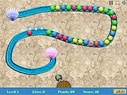 Fairy Pearls game screenshot showing a magical frog cannon shooting a colored pearl towards a long, winding chain of multi-colored pearls