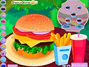 Screenshot of the free online game Cheeseburger Decoration showing a massive burger stack with a patty, cheese, lettuce, tomato, and multiple toppings.