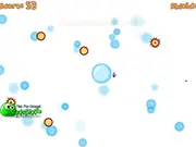 The player's nano ship shooting bright projectiles at a cluster of red bubble-like viruses in the Bubble Virus free online game.