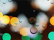 Pink Morning game screenshot showing a large waterdrop on a window pane in soft sunrise light, surrounded by smaller droplets to collect