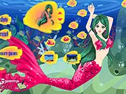 A beautifully dressed mermaid sitting on a sandy beach wearing a shimmering tail and seashell top in the game Sandy Beach Mermaid