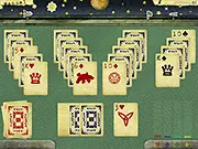 Astral Solitaire screenshot showing a golf solitaire card layout on a retro sci-fi background with a spaceship and a flag goal. Free online card game.