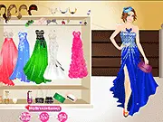 Screenshot of the Celebrity Inspired Prom Dresses game showing a female model wearing an elegant red carpet-style prom gown, with various fashion options around her.