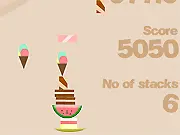 Screenshot of The Food Stack online game showing a platter catching and balancing a tall, unstable stack of falling food items