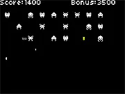 The Space Defence free online game screenshot showing a paddle deflecting an enemy bullet back at a retro pixelated space invader