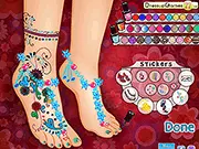 A screenshot of the Fabulous Foot Makeover game showing a close-up of a foot receiving a pedicure with various nail polish colors, gems, and accessories available.