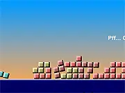 Screenshot from Crystal Towers showing a precarious tower of colored crystal blocks stacked high against a blue background. Play free online physics game.