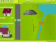 Screenshot of Sssnake Classic online game showing a long snake navigating a neighborhood map filled with environmental obstacles like houses and fences, reaching for an apple.