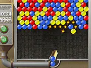 Screenshot of Crusher online game showing a cannon aiming a colored ball at a descending mass of multi-colored balls in an arcade environment