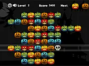 Gameplay screenshot of Halloween Pumpkins showing a grid filled with various colored carved pumpkin blocks, with a new block descending from the top.