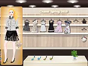 The main screen of the Chanel Spring 2010 Dress Up game, showing a model character and a selection of elegant designer clothing and accessories from the famous collection