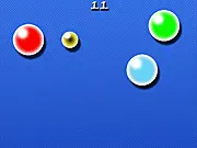 A mouse cursor separating two rapidly bouncing colorful balls in the addictive arcade high-score game The Juggler