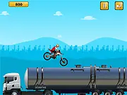 Extreme Bike Stunts Online free game screenshot featuring a dirt bike performing a difficult stunt jump over a large gap on PlayArcadeHub