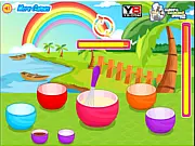 Rainbow Cupcakes online baking game screenshot, showing a multi-colored cake being decorated